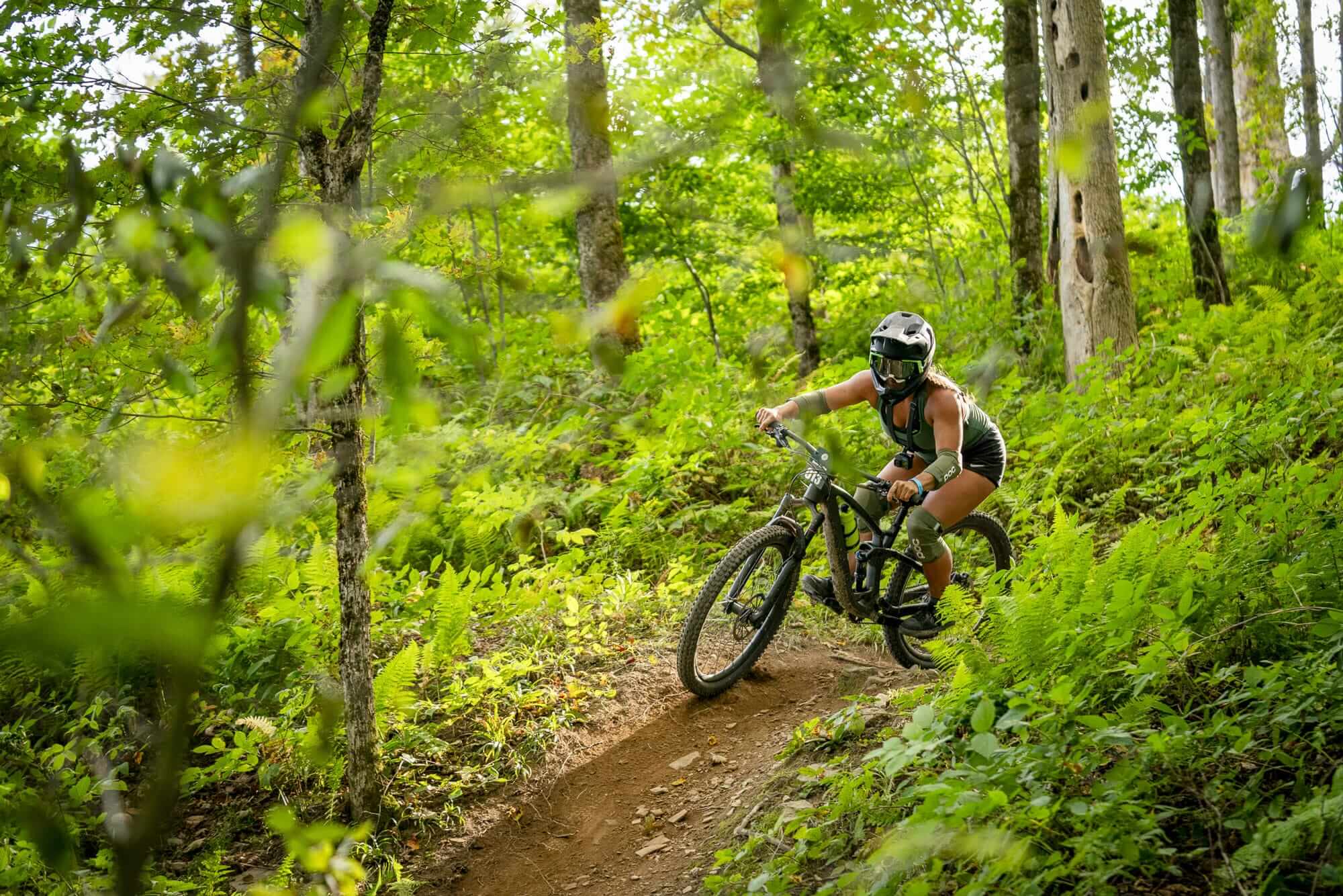 Woman mountain biking at HoliMont Bike Park on a summer day